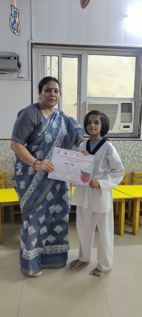 Student receiving Certificate of Merit from dignitary at Taekwondo Championship